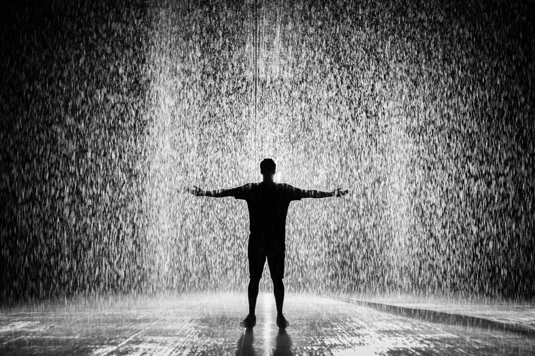 silhouette of man in rain black and white